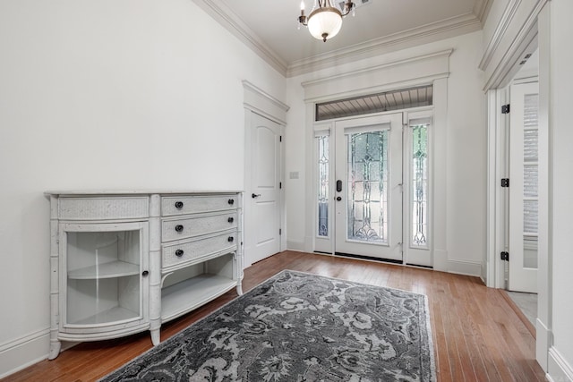 entrance foyer featuring hardwood / wood-style floors and crown molding