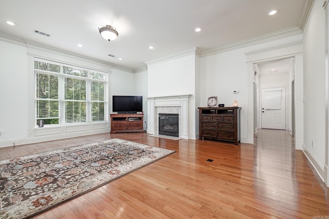 living room featuring crown molding and light hardwood / wood-style flooring