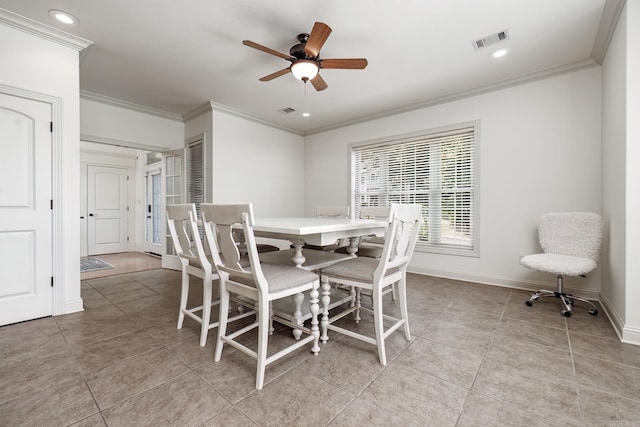 tiled dining room with ceiling fan and ornamental molding