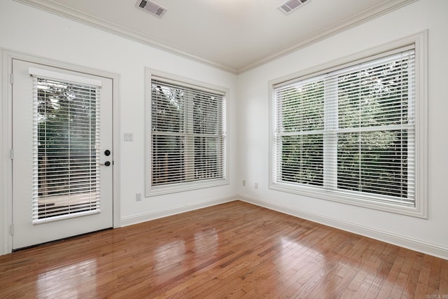 unfurnished room with hardwood / wood-style floors and ornamental molding