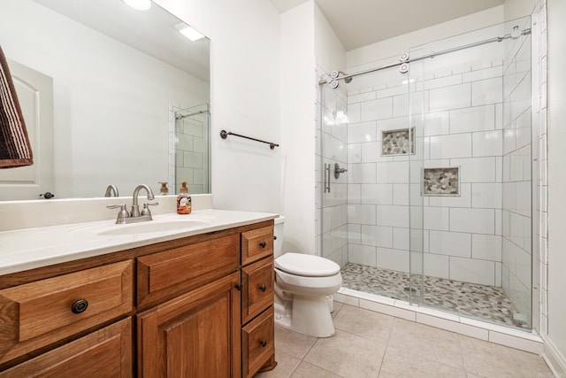 bathroom featuring a shower with door, toilet, tile patterned floors, and vanity