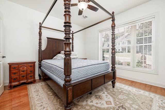 bedroom with light wood-type flooring and ceiling fan