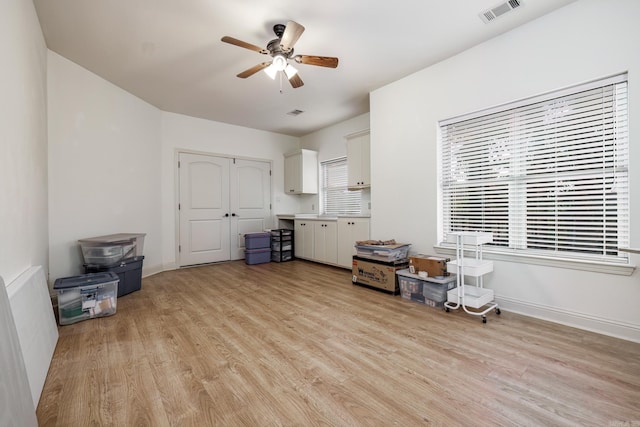 living room with ceiling fan and light hardwood / wood-style floors