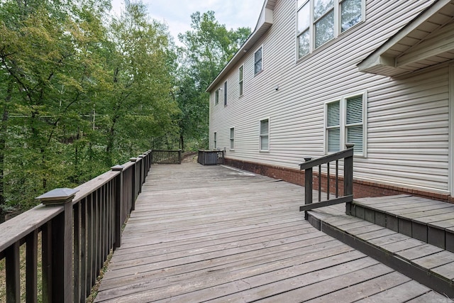 wooden deck featuring central air condition unit