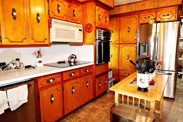 kitchen with stainless steel refrigerator with ice dispenser, dishwasher, wall oven, black electric stovetop, and tile patterned flooring