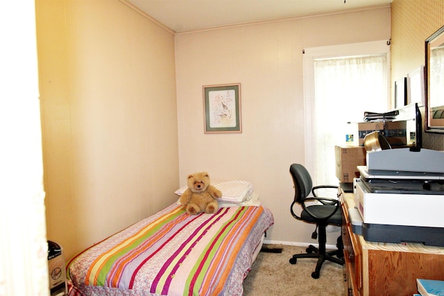 carpeted bedroom with ornamental molding