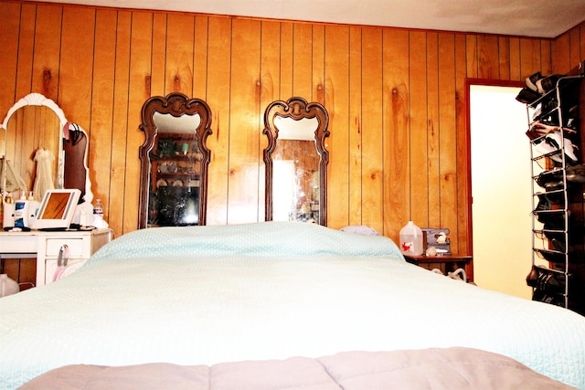 bedroom featuring wood walls