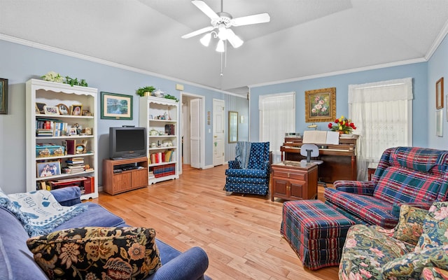 living room featuring crown molding, ceiling fan, and light hardwood / wood-style flooring