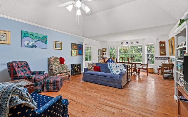 living room with crown molding, vaulted ceiling, light hardwood / wood-style floors, and a textured ceiling