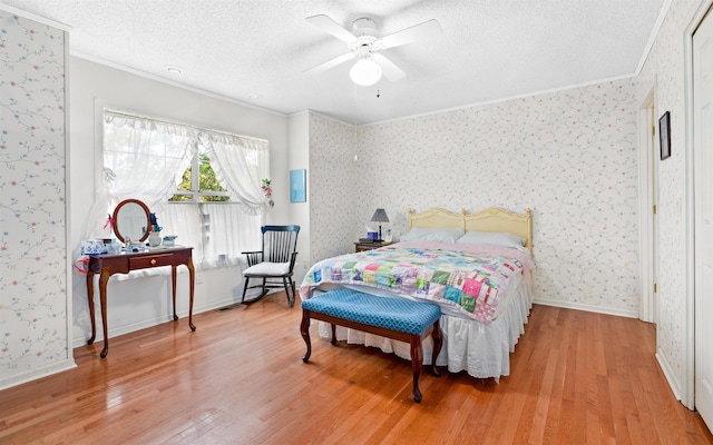 bedroom featuring ornamental molding, wood-type flooring, and a textured ceiling