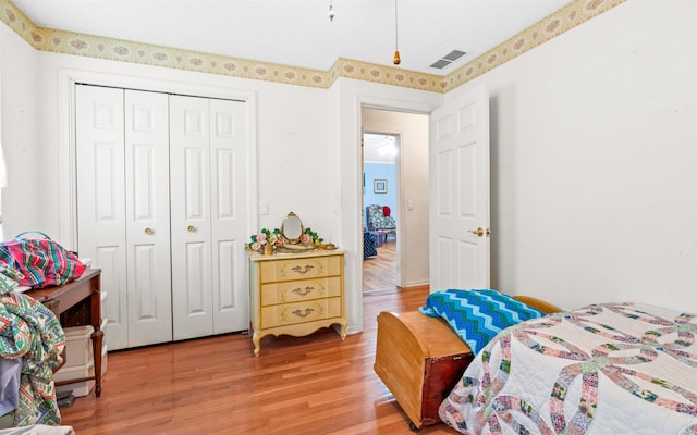 bedroom featuring hardwood / wood-style flooring and a closet