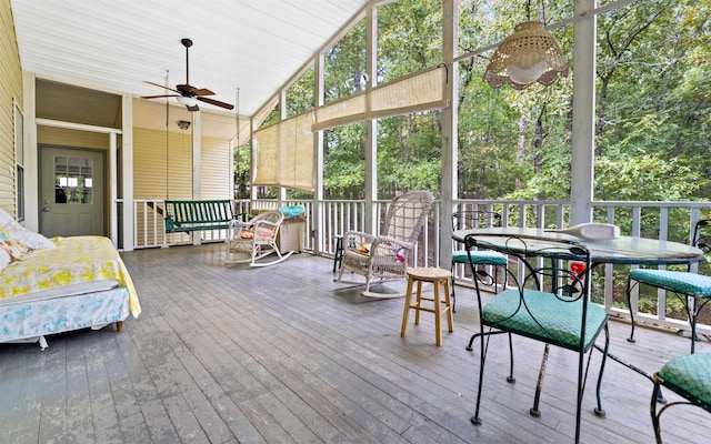 sunroom featuring vaulted ceiling and ceiling fan