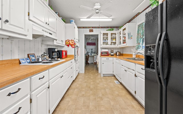 kitchen featuring white cabinetry, sink, white appliances, ceiling fan, and a textured ceiling