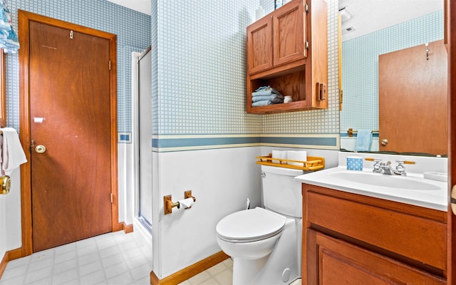 bathroom featuring vanity, an enclosed shower, and toilet