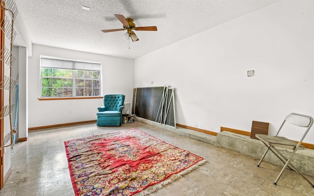 sitting room featuring ceiling fan and a textured ceiling