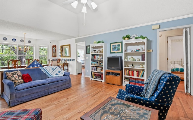 living room featuring vaulted ceiling, light wood-type flooring, ceiling fan, crown molding, and a textured ceiling