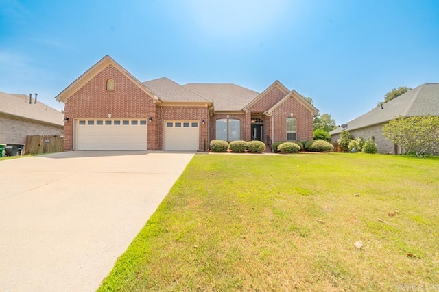 view of front of house with a front yard and a garage