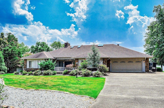 ranch-style house featuring a front lawn and a garage