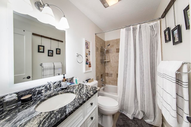 full bathroom with a textured ceiling, toilet, shower / tub combo, and vanity