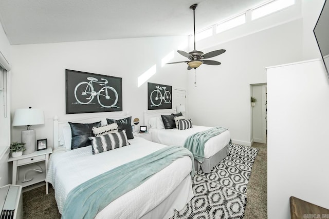 bedroom with ceiling fan, high vaulted ceiling, and carpet floors