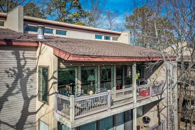 back of house with cooling unit and a balcony