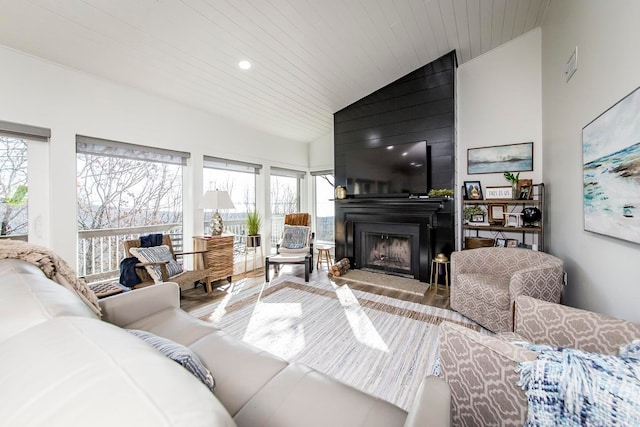 living room featuring vaulted ceiling, hardwood / wood-style flooring, and plenty of natural light