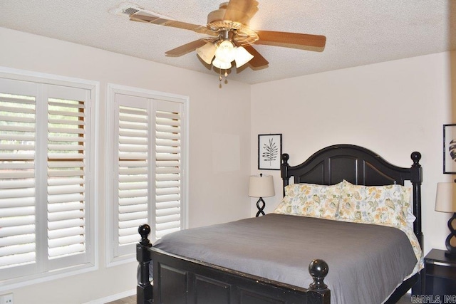 bedroom featuring a textured ceiling and ceiling fan