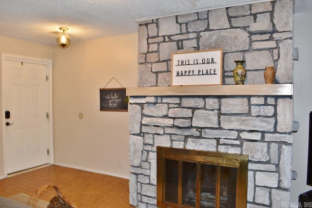 details featuring a textured ceiling, a stone fireplace, and tile patterned floors