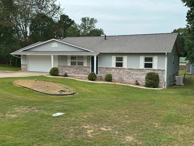 ranch-style home featuring a front lawn, central AC unit, and a garage