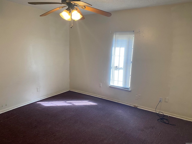 carpeted spare room with ceiling fan and a textured ceiling