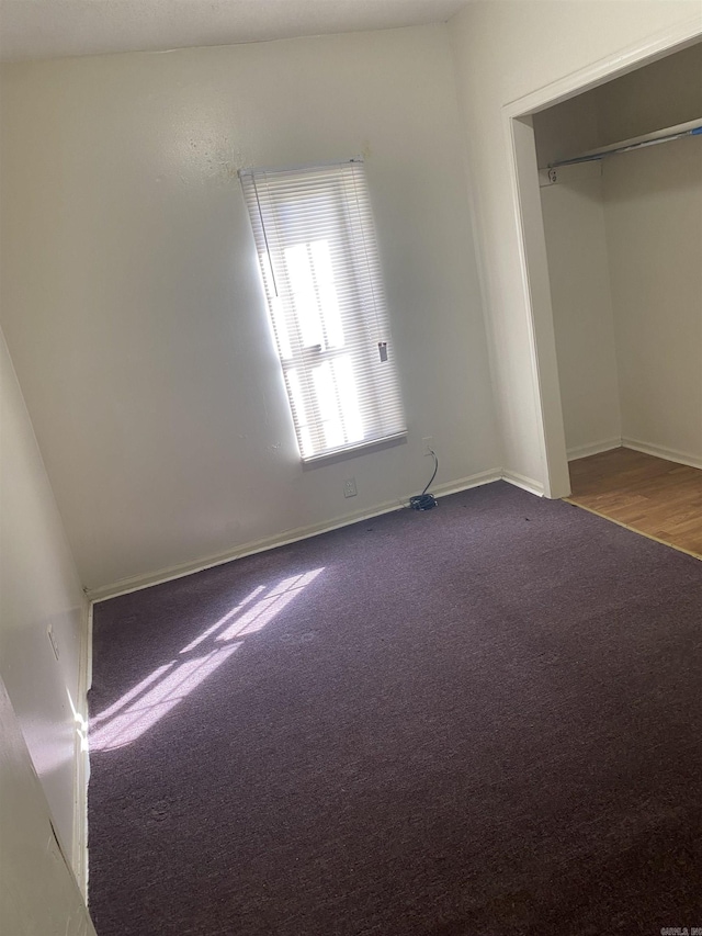 unfurnished bedroom featuring carpet flooring and baseboards