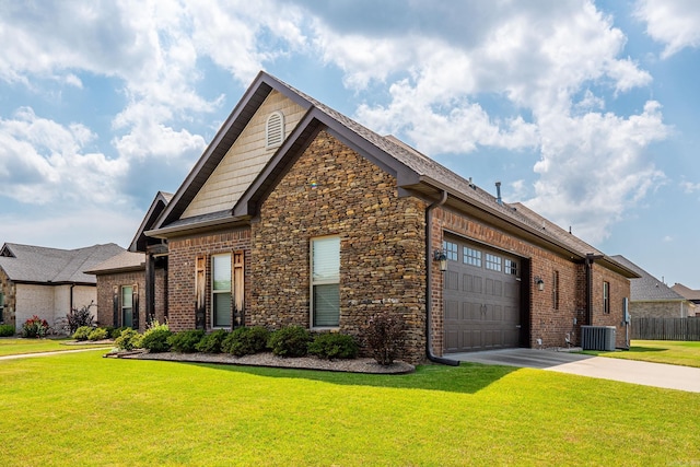 view of front facade with a garage, cooling unit, and a front yard