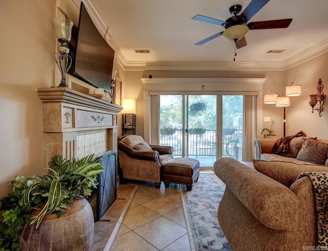 tiled living room with ornamental molding and ceiling fan