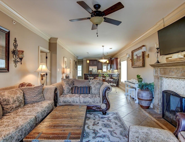 tiled living room featuring crown molding and ceiling fan