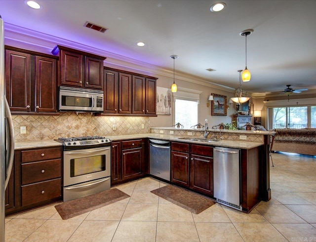 kitchen featuring appliances with stainless steel finishes, kitchen peninsula, light tile patterned floors, and ceiling fan