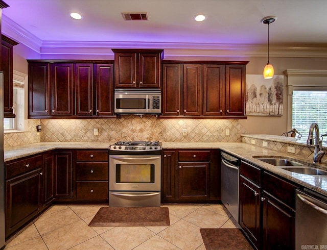 kitchen featuring light tile patterned floors, appliances with stainless steel finishes, light stone countertops, sink, and backsplash