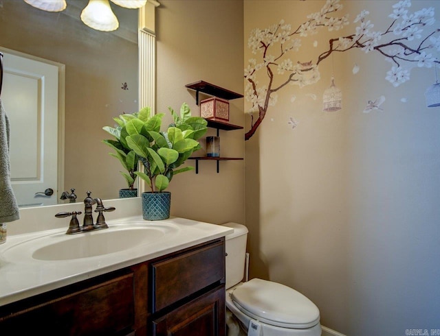 bathroom with toilet and vanity