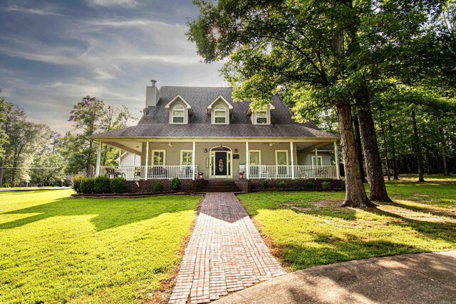 373 S Brandon, Fordyce, AR 71742 - country-style home featuring a front lawn, covered porch, and a chimney