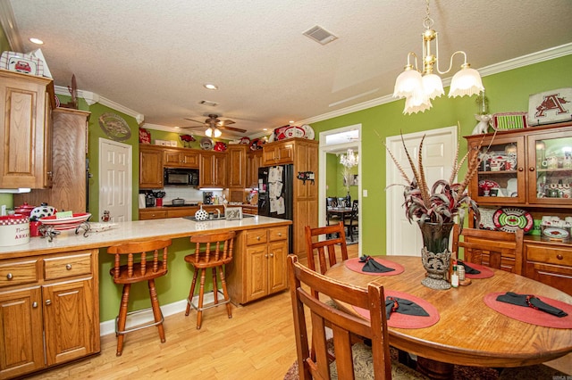 373 S Brandon, Fordyce, AR 71742 - dining space with visible vents, crown molding, and light wood finished floors