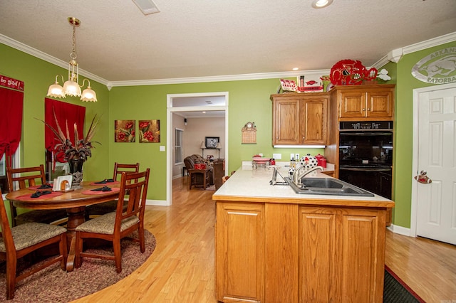 373 S Brandon, Fordyce, AR 71742 - kitchen with ornamental molding, light wood-style floors, and a sink