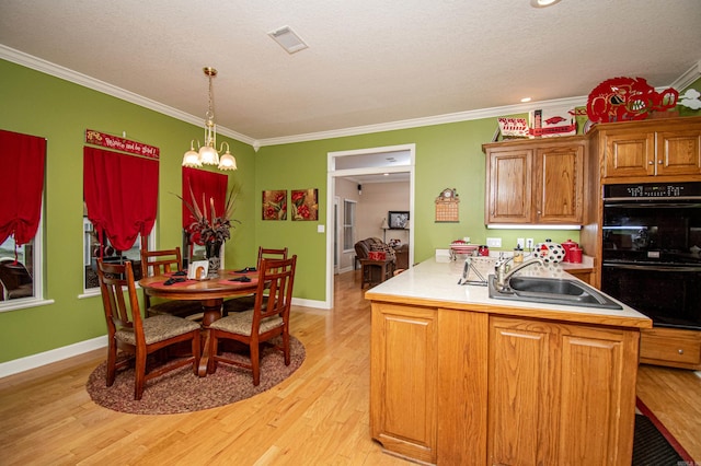 373 S Brandon, Fordyce, AR 71742 - kitchen featuring dobule oven black, a sink, a chandelier, light wood-type flooring, and ornamental molding