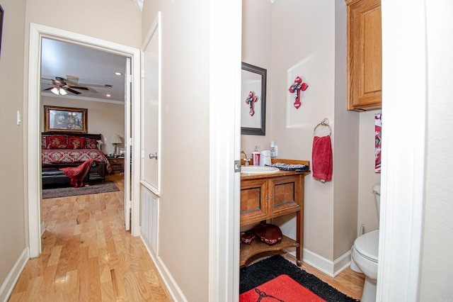 373 S Brandon, Fordyce, AR 71742 - ensuite bathroom featuring wood finished floors, toilet, vanity, a ceiling fan, and crown molding