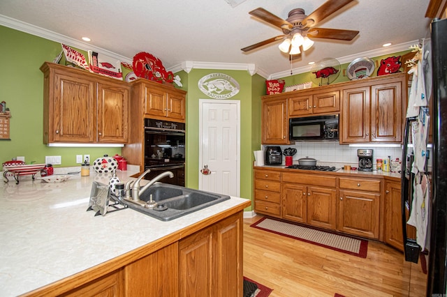 373 S Brandon, Fordyce, AR 71742 - kitchen featuring black appliances, light countertops, crown molding, and a sink