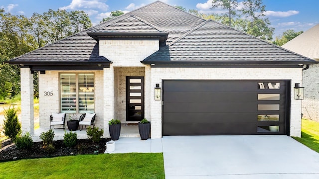 view of front facade featuring a garage and covered porch