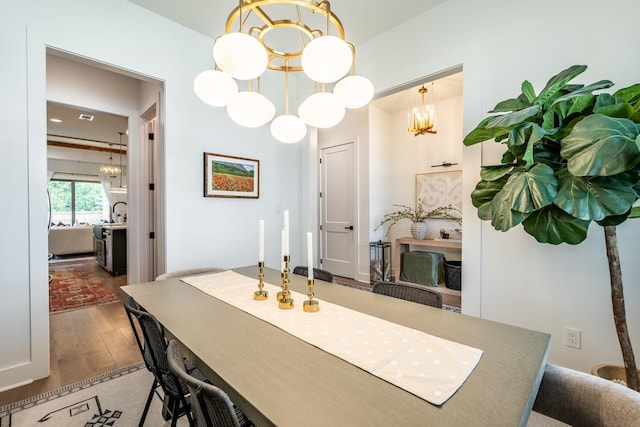 dining area featuring an inviting chandelier and dark hardwood / wood-style flooring