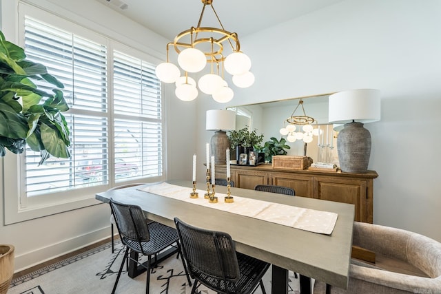 dining room with a notable chandelier and light hardwood / wood-style floors