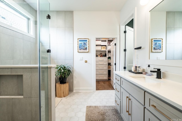 bathroom featuring an enclosed shower, vanity, and tile patterned flooring