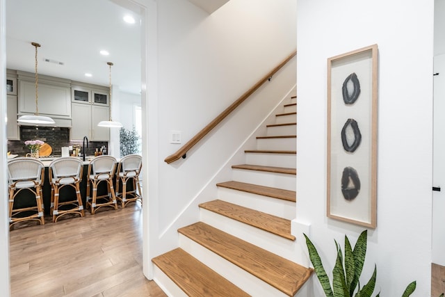 stairs with hardwood / wood-style flooring