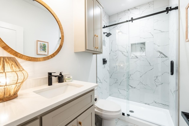 bathroom with vanity, toilet, and a shower with door