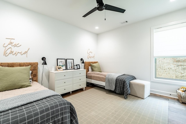 bedroom with ceiling fan and light hardwood / wood-style flooring